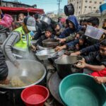 Des Palestiniens attendent un repas chaud préparé par des bénévoles à Rafah, dans le sud de la bande de Gaza, le 26 janvier 2024. (Abed Rahim Khatib/Flash90)